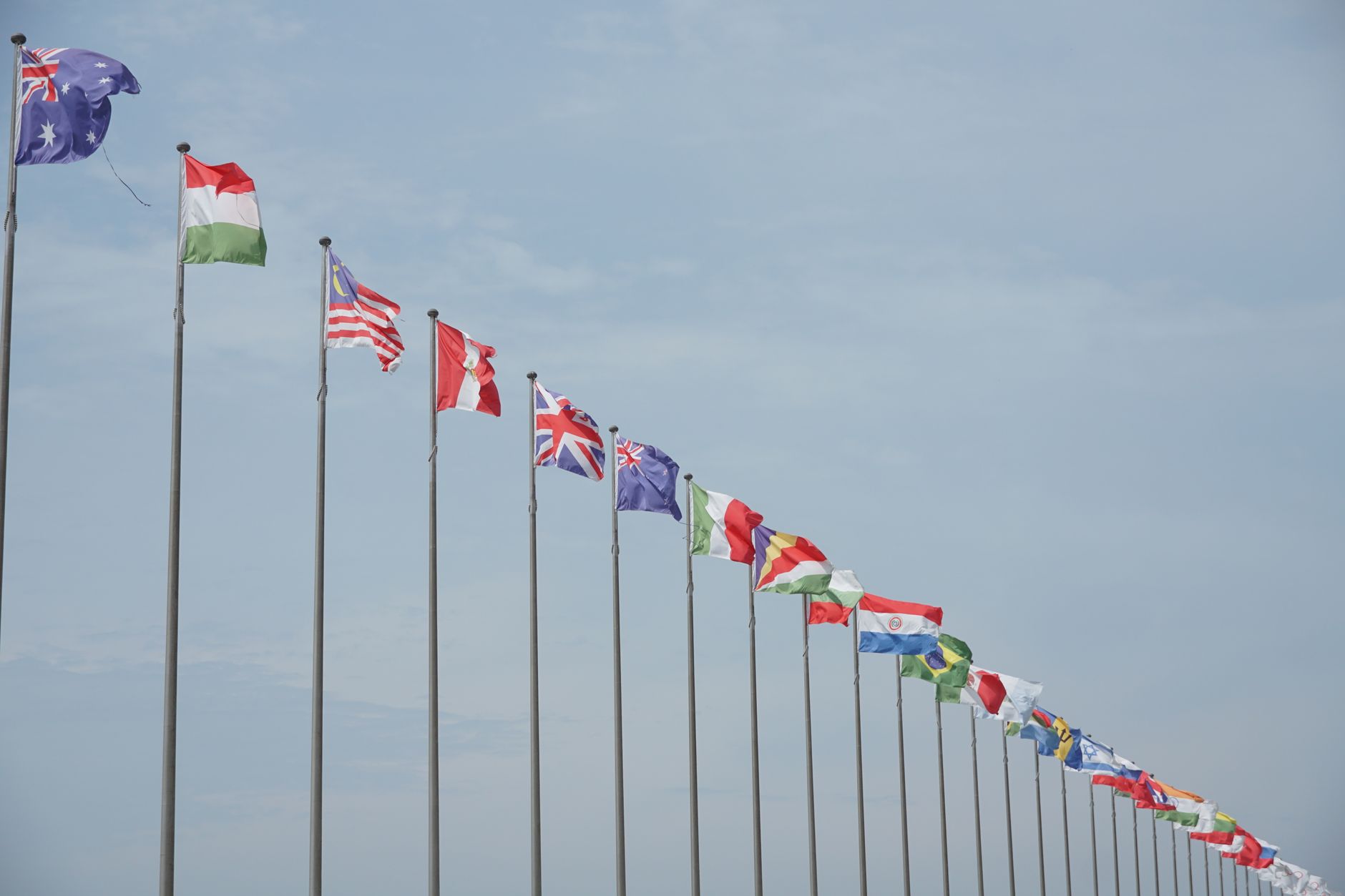 A row of international flags on flagpoles symbolizing global unity and diplomacy