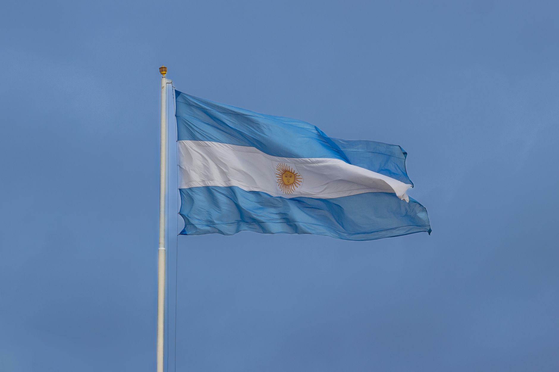The national flag of Argentina waving against a clear blue sky in Buenos Aires