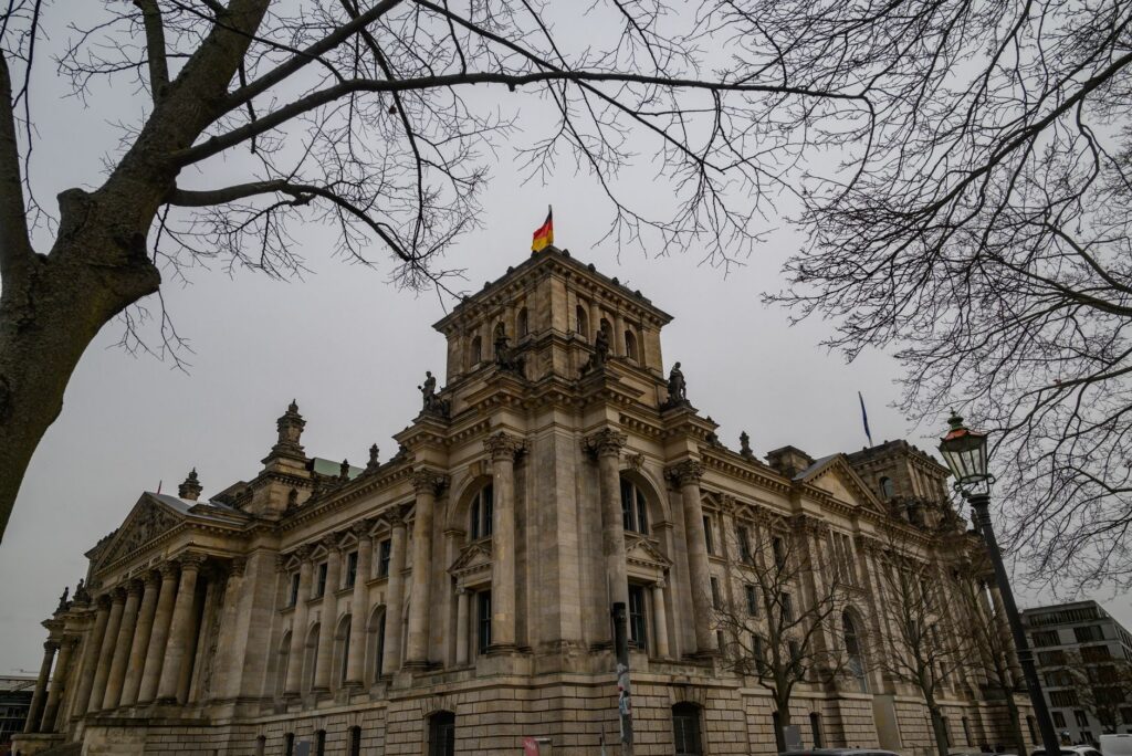 The Reichstag building in Berlin, Germany, framed by bare winter trees