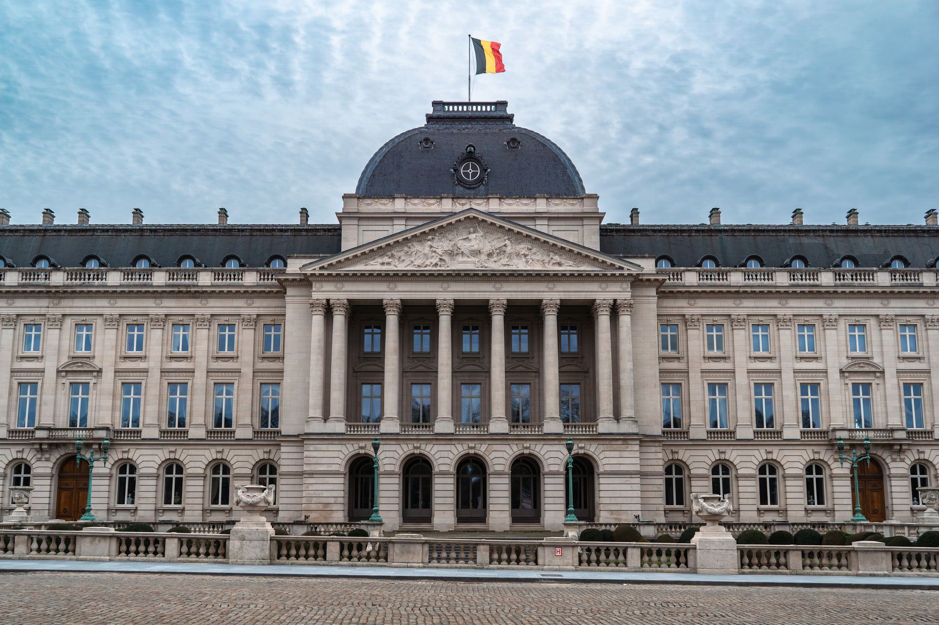 Front view of the Royal Palace of Brussels with the Belgian flag