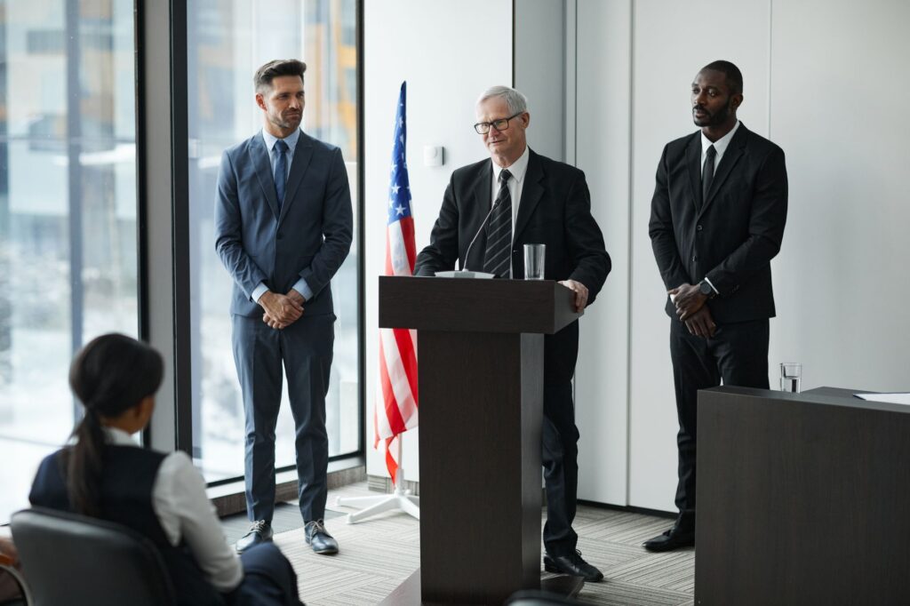 Officials delivering a political speech in a conference room