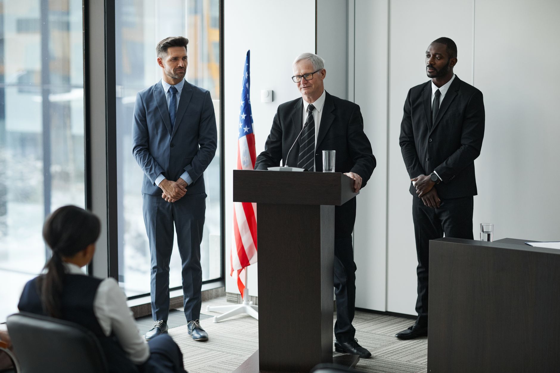 Officials delivering a political speech in a conference room