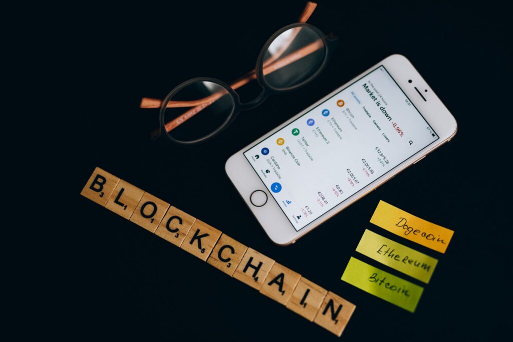 Smartphone displaying cryptocurrency market data alongside blockchain concept elements