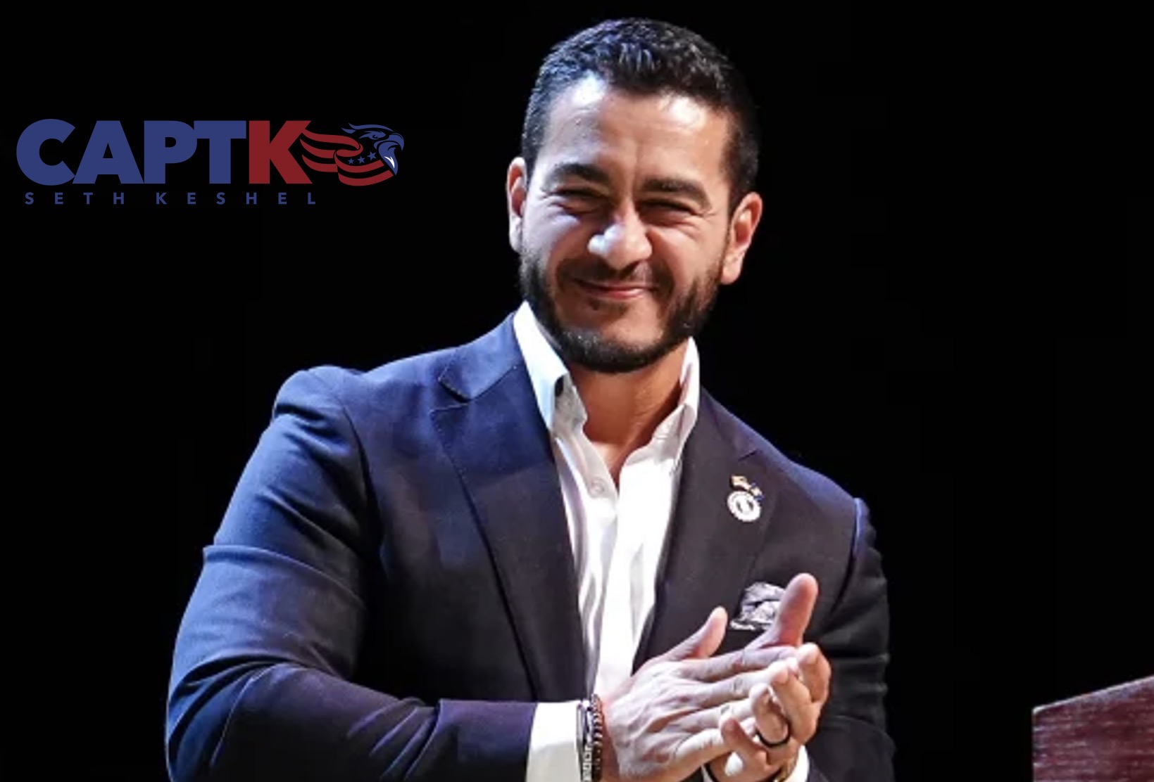 Michigan Democratic U.S. Senate nominee Abdul El-Sayed applauding on stage