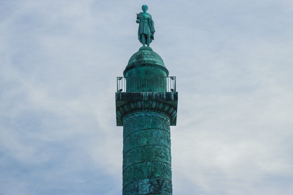 The statue of Napoleon atop the Colonne Vendome in Paris, evoking Napoleon's maxim on never interrupting an enemy who is making a mistake