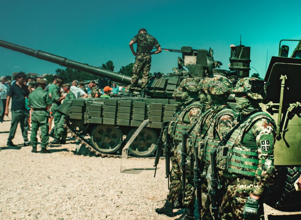 Camouflaged soldiers near a tank during a training exercise