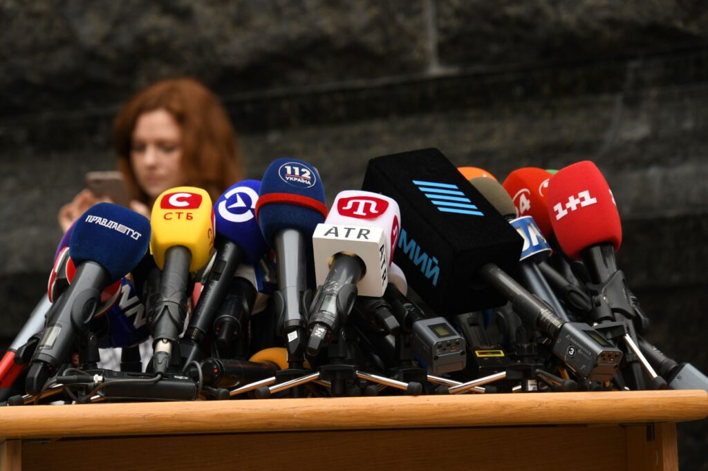 Microphones set up at a press conference
