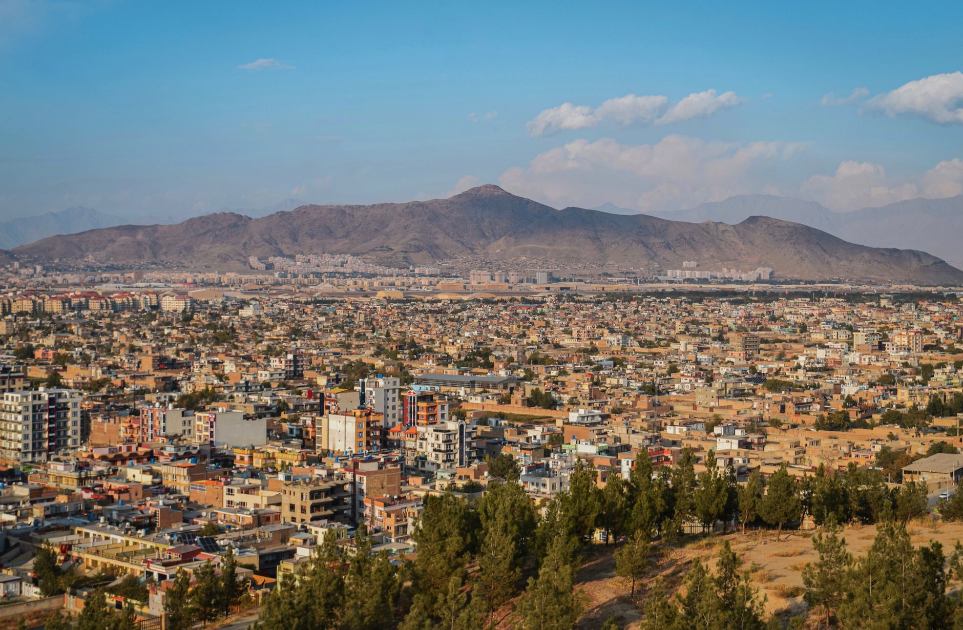 Aerial cityscape of Kabul, Afghanistan with mountains in the background