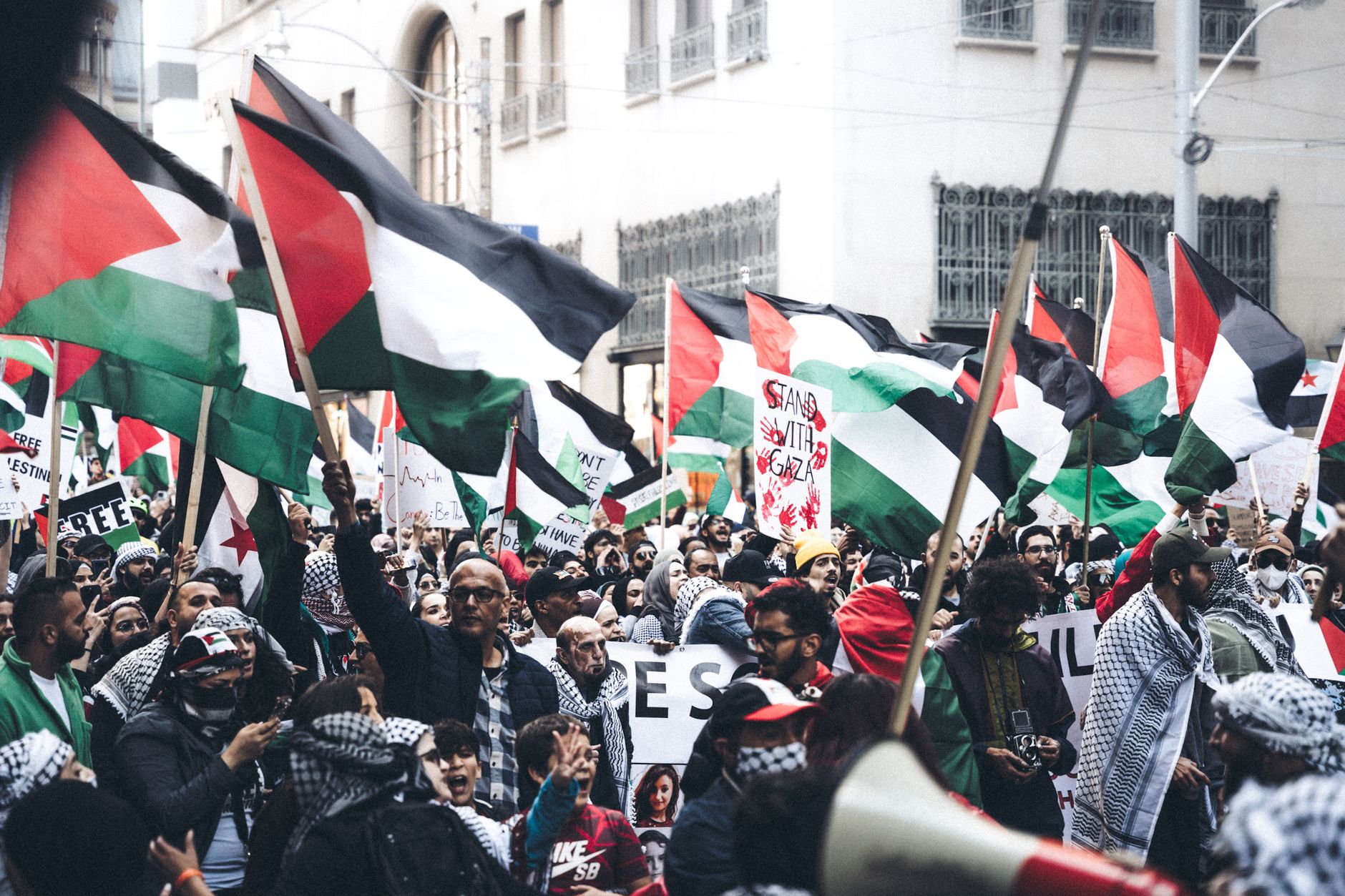 Demonstrators holding Palestinian flags at a protest