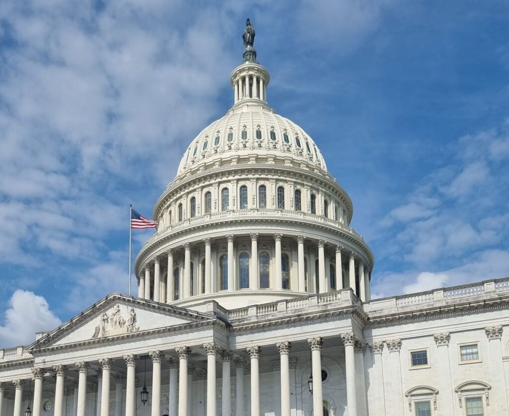 The US Capitol dome with an American flag