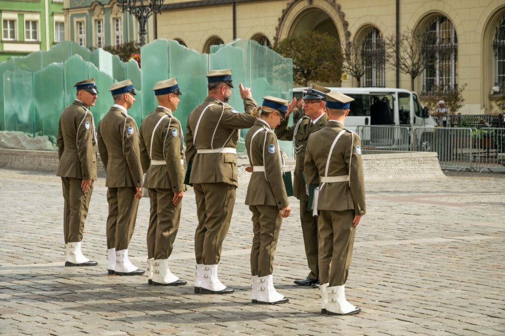 Military personnel in uniform standing at a parade in Central Europe