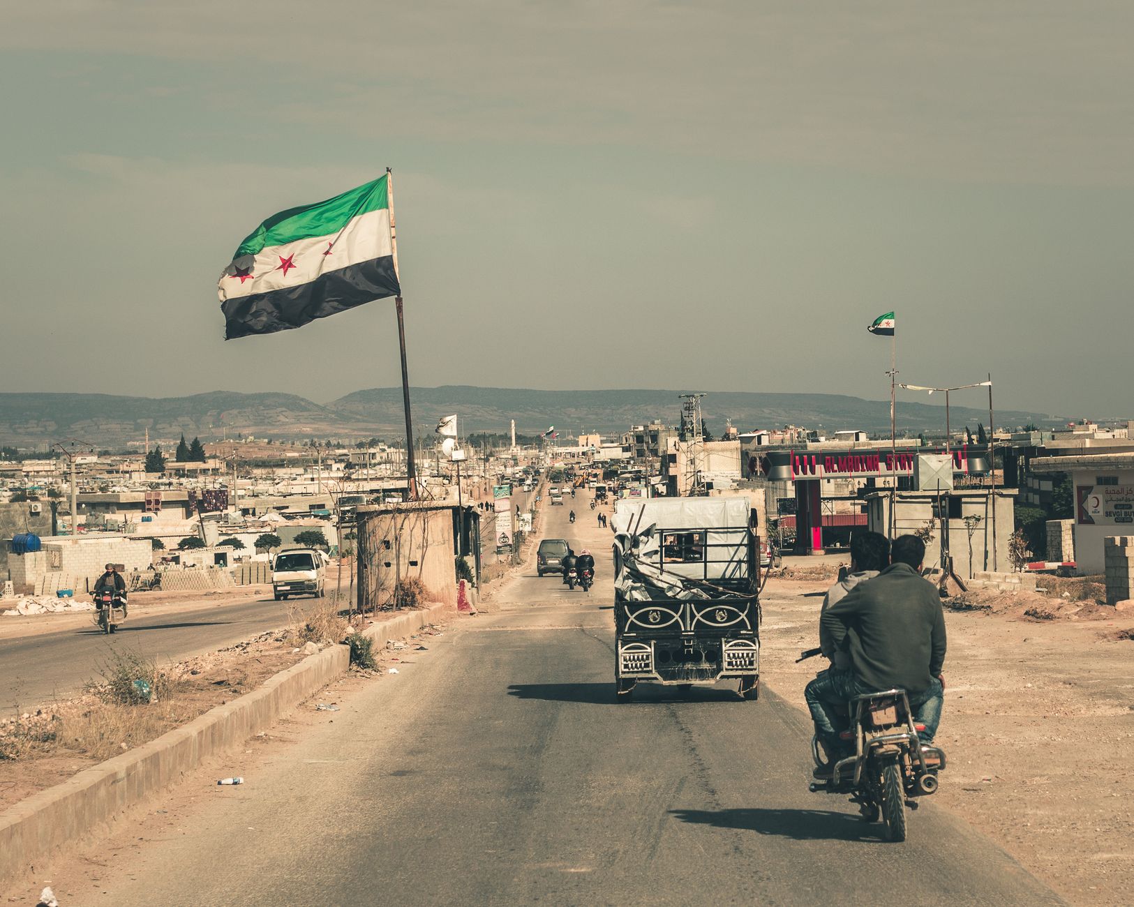 Middle Eastern town street with a flag