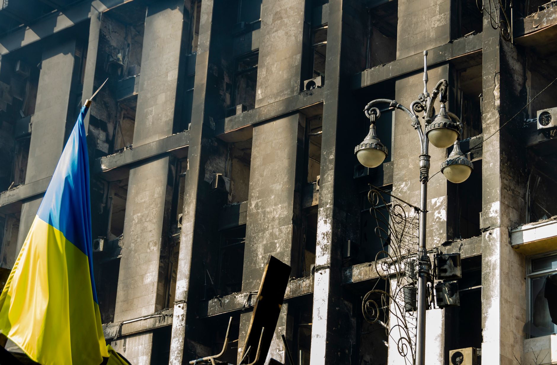 A damaged building in Kyiv, Ukraine with the Ukrainian flag