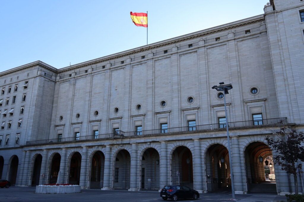 Historic government building in Spain with a Spanish flag