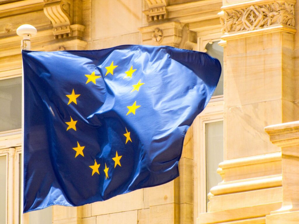 European Union flag waving against historic architecture