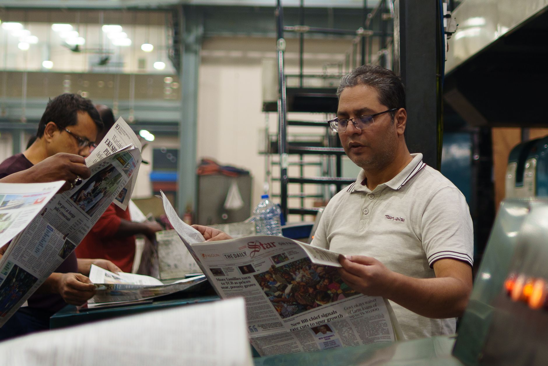 Workers at a newspaper printing press