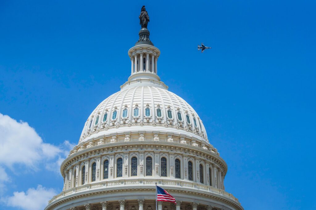 The US Capitol dome with a jet flying above in Washington DC