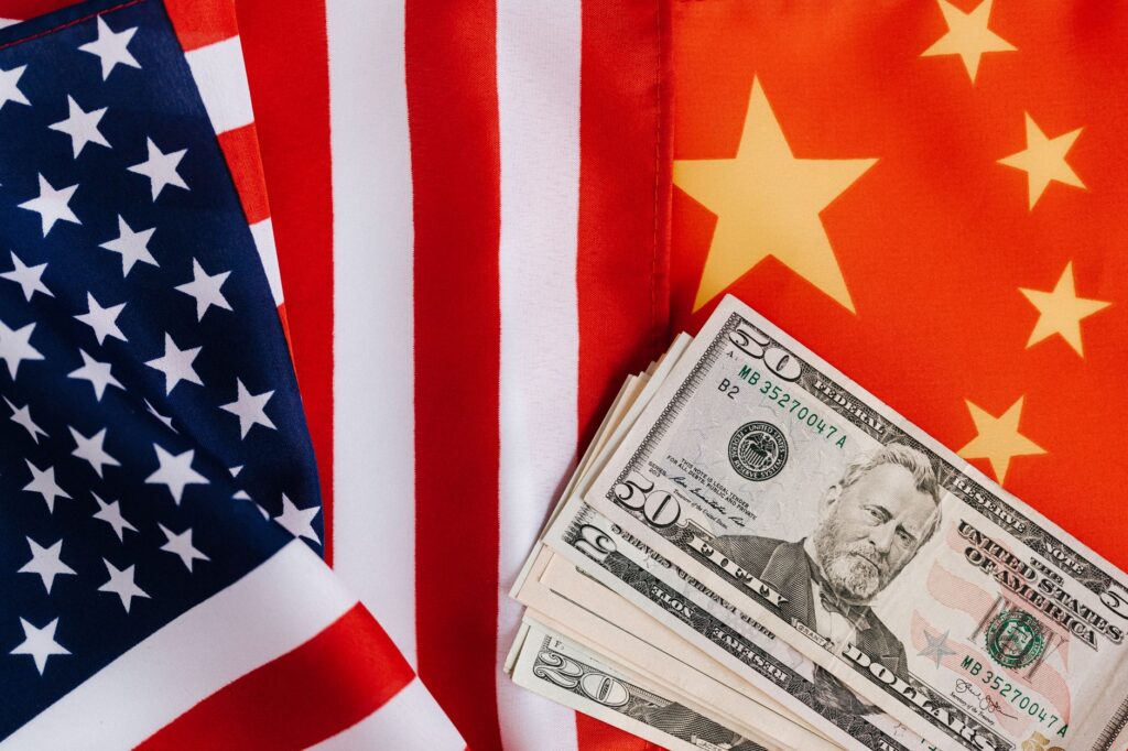 US banknotes placed on the national flags of America and China