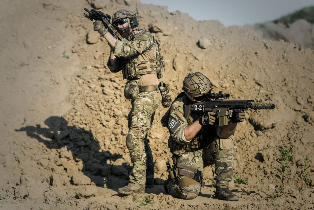Two soldiers in camouflage during a tactical operation